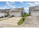 Charming townhome featuring a two-car garage, neutral siding, and well-manicured landscaping, all under a sunny sky at 5622 Osprey Cove Dr, Raleigh, NC 27604