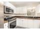 Efficient kitchen with white cabinets, stainless steel appliances, and ample counter space for meal preparation at 5622 Osprey Cove Dr, Raleigh, NC 27604