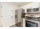 Well-equipped kitchen with stainless steel appliances, white cabinetry, and ample storage space for culinary enthusiasts at 5622 Osprey Cove Dr, Raleigh, NC 27604