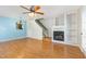 Living room featuring hardwood floors, fireplace, and a view to the staircase with natural light flooding the space at 5622 Osprey Cove Dr, Raleigh, NC 27604