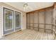 Relaxing screened-in porch with a ceiling fan and wooden lattice on the back of house at 5622 Osprey Cove Dr, Raleigh, NC 27604