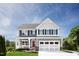Charming two-story home with a covered porch, gray siding and a well-manicured lawn at 568 Impala, Wendell, NC 27591