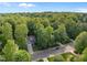 Beautiful aerial view of a home nestled among lush green trees with a long driveway at 606 Churton Grove Blvd, Hillsborough, NC 27278