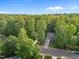 Scenic aerial view of the home set amidst mature trees, showcasing the serene neighborhood at 606 Churton Grove Blvd, Hillsborough, NC 27278