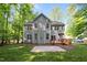 Large backyard with a deck, patio and lush green lawn at 606 Churton Grove Blvd, Hillsborough, NC 27278
