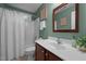 Bathroom with green walls, tiled floors, and a shower over the tub with white curtain at 606 Churton Grove Blvd, Hillsborough, NC 27278
