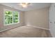 Bedroom with neutral walls, carpeted floor, and a window at 606 Churton Grove Blvd, Hillsborough, NC 27278