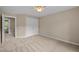 Bedroom with neutral walls, carpeted floor, ceiling fan, and closet at 606 Churton Grove Blvd, Hillsborough, NC 27278