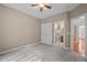 Neutral bedroom with plush carpeting, showcasing access to a bathroom and closet for convenience at 606 Churton Grove Blvd, Hillsborough, NC 27278