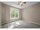 A serene bedroom featuring a large window that bathes the space in natural light, with soft carpeting at 606 Churton Grove Blvd, Hillsborough, NC 27278