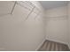 Walk-in closet with white walls and carpeted floor with metal racks for storage at 606 Churton Grove Blvd, Hillsborough, NC 27278
