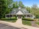Inviting clubhouse with classic design, a welcoming porch, and meticulously landscaped grounds at 606 Churton Grove Blvd, Hillsborough, NC 27278