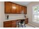 An office space featuring brown cabinets, a white counter, and a window providing natural light at 606 Churton Grove Blvd, Hillsborough, NC 27278