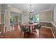Formal dining room featuring hardwood floors, modern chandelier, and easy access to the living spaces at 606 Churton Grove Blvd, Hillsborough, NC 27278
