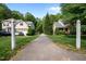 Inviting driveway leading to beautiful homes surrounded by lush greenery and blue skies at 606 Churton Grove Blvd, Hillsborough, NC 27278