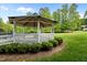 Charming gazebo surrounded by manicured landscaping and lush green grass, perfect for relaxation at 606 Churton Grove Blvd, Hillsborough, NC 27278