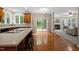 Spacious kitchen with hardwood floors, central island, and seamless connection to the adjoining living room at 606 Churton Grove Blvd, Hillsborough, NC 27278