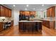 Gourmet kitchen featuring hardwood floors, custom cabinetry, and a center island with seating at 606 Churton Grove Blvd, Hillsborough, NC 27278