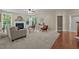 Inviting living room showcasing fireplace, carpet, and seamless transition to hardwood flooring near the doorway at 606 Churton Grove Blvd, Hillsborough, NC 27278