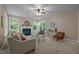 Comfortable living room with neutral tones, a fireplace, and large windows offering ample natural light at 606 Churton Grove Blvd, Hillsborough, NC 27278