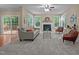 Cozy living room featuring plush carpet, large windows, a fireplace, and a sliding door to the outdoors at 606 Churton Grove Blvd, Hillsborough, NC 27278