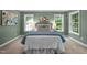 A main bedroom features a bed with blue and white bedding, two lamps and artwork above the headboard at 606 Churton Grove Blvd, Hillsborough, NC 27278