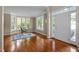 Home office area featuring hardwood floors, bright light from many windows, and an elegant desk at 606 Churton Grove Blvd, Hillsborough, NC 27278