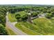 Beautiful aerial view highlighting the property's rural charm near a quaint roadside at 61 Stone Ledge, Pittsboro, NC 27312