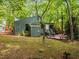 Back exterior view featuring a deck, walkout basement, and a wooded lot at 61 Stone Ledge, Pittsboro, NC 27312