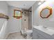 Updated bathroom with tiled shower, gray vanity, and framed mirror at 61 Stone Ledge, Pittsboro, NC 27312