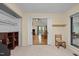 Bonus room featuring carpeted floors, access to another room, closet and a large window at 61 Stone Ledge, Pittsboro, NC 27312