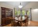 Bright dining room featuring a wooden dining set, hardwood floors, and built-in shelving at 61 Stone Ledge, Pittsboro, NC 27312