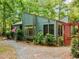 Inviting home exterior with beautiful landscaping, a patriotic flag, and a cozy outdoor space at 61 Stone Ledge, Pittsboro, NC 27312