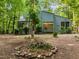 Beautiful home with an American flag, surrounded by lush landscaping and a natural setting at 61 Stone Ledge, Pittsboro, NC 27312