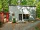 Home exterior with wood siding, black trim, and a landscaped front yard at 61 Stone Ledge, Pittsboro, NC 27312