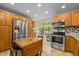 Modern kitchen with stainless appliances, wooden cabinets and an eat-in breakfast nook with backyard views at 61 Stone Ledge, Pittsboro, NC 27312
