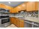 Updated kitchen showcasing granite counters, stainless steel appliances, and ample cabinet space at 61 Stone Ledge, Pittsboro, NC 27312