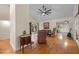 Spacious living room with hardwood floors, a ceiling fan, and sliding door access to the deck at 61 Stone Ledge, Pittsboro, NC 27312