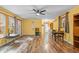 Bright living room with hardwood floors, ceiling fan, and large windows for ample natural light at 61 Stone Ledge, Pittsboro, NC 27312
