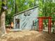 Charming backyard outbuilding complete with basketball hoop and decorative pergola at 61 Stone Ledge, Pittsboro, NC 27312