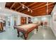 Finished basement with pool table, exposed beams, and painted brick wall providing a recreational space at 612 Swift Ave, Durham, NC 27701