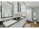 Bathroom featuring double sinks, granite countertops, and a walk-in shower at 612 Swift Ave, Durham, NC 27701