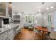 Open dining area with hardwood floors, large windows, and modern lighting fixtures at 612 Swift Ave, Durham, NC 27701