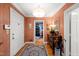 Inviting entryway featuring hardwood floors, a decorative rug, and wood-paneled walls at 612 Swift Ave, Durham, NC 27701
