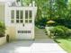 Rear exterior of home with patio access from the garage and lush backyard at 612 Swift Ave, Durham, NC 27701