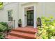 Elegant front entrance with a black door, brick steps, and manicured greenery for a welcoming appeal at 612 Swift Ave, Durham, NC 27701