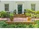 Inviting front entrance with brick steps, iron railing, and well-maintained landscaping at 612 Swift Ave, Durham, NC 27701
