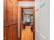 Hallway with hardwood floors and dark stained built-in cabinets, leading to an office space at 612 Swift Ave, Durham, NC 27701