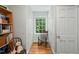 Hallway featuring hardwood floors, natural light from a window, and built in book shelves at 612 Swift Ave, Durham, NC 27701