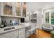 Kitchen bar featuring stainless steel appliances, glass front display cabinets and island at 612 Swift Ave, Durham, NC 27701